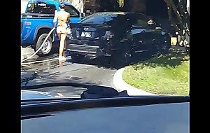 Sexy legal age teenager washing car in 2 piece bikini