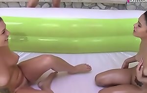 BFFs oil wrestling in inflatable pool