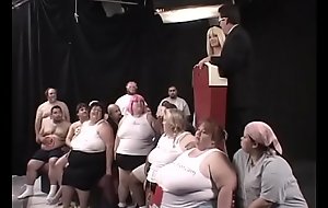 Two dozens of lard-asses suck, lick and fuck each other during The Worlds First 300 Lb Gang Bang, organized by ingenious beauty Kat Kleevage