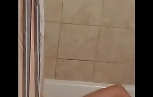 Spying on MILF enjoying a dildo in the bath.